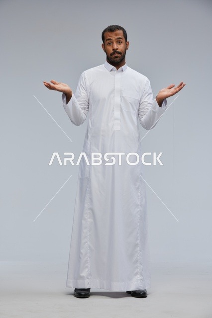 Saudi Man in White Thobe Shrugging in Studio Portrait