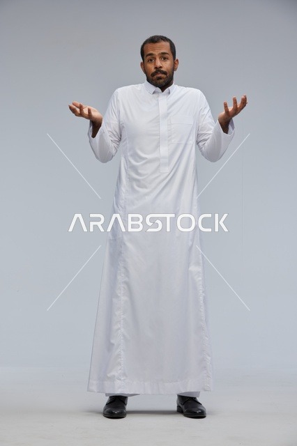 Saudi Man in Traditional White Thobe Shrugging in Studio