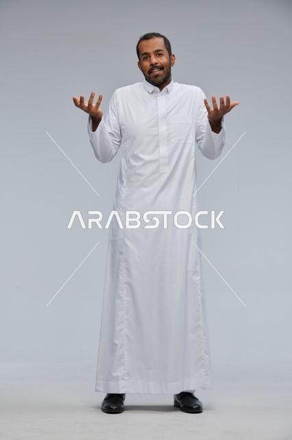 Saudi Man in White Thobe Gesturing on Grey Background