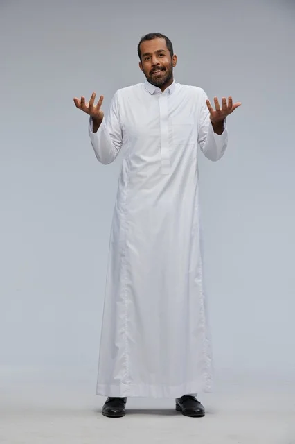 Saudi Man in White Thobe Gesturing on Grey Background