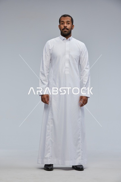 Saudi Man in Traditional White Thobe Standing in Studio