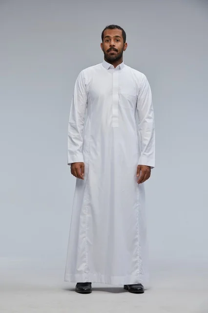 Saudi Man in Traditional White Thobe Standing in Studio