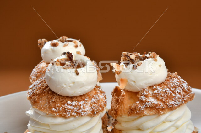 A plate of cold sweets decorated with cream, oriental sweets, Ramadan sweets, sweets and sugars, delicious sweets, sweets, delicious cold sweets