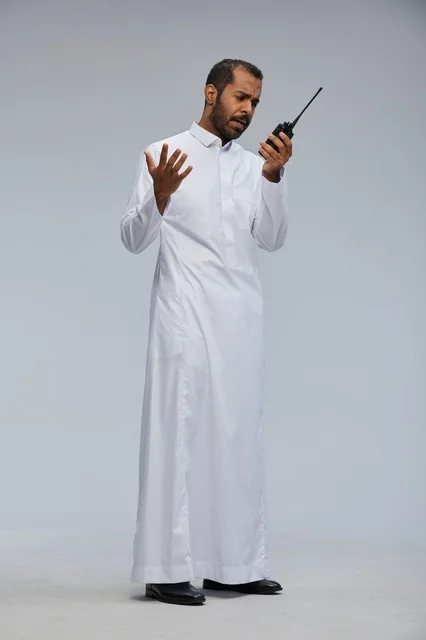 Saudi Man in White Thobe Using Walkie Talkie in Studio