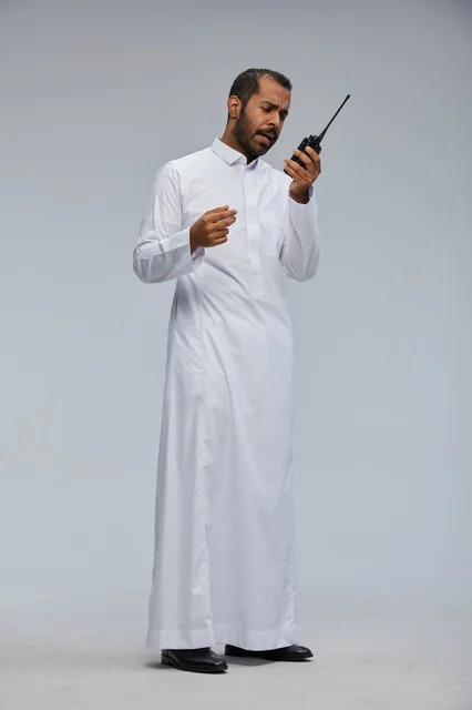 Saudi Man in White Thobe Using Walkie Talkie in Studio
