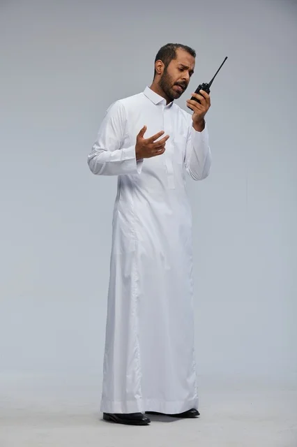 Saudi Man in White Thobe Using Walkie Talkie Radio