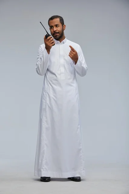 Saudi Man in White Thobe Using Walkie Talkie Radio