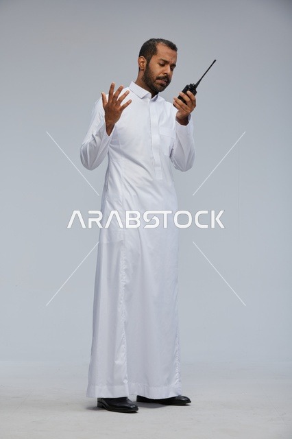 Saudi Man in White Thobe Using Walkie Talkie Studio