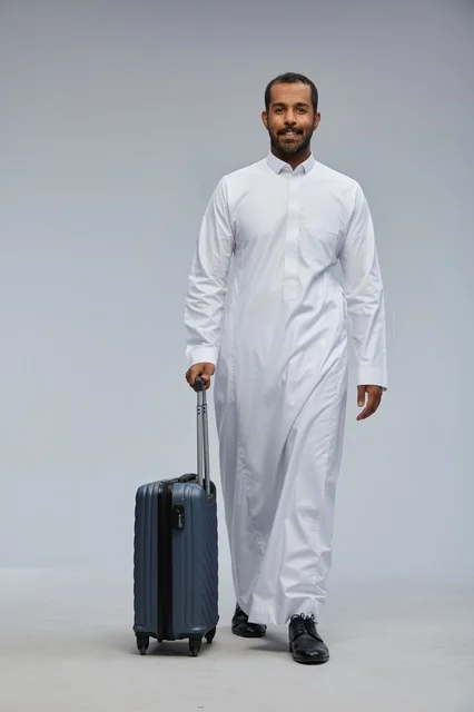 Saudi Man Traveler with Blue Suitcase in Studio