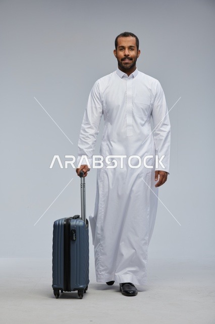 Saudi Man in White Thobe with Blue Suitcase