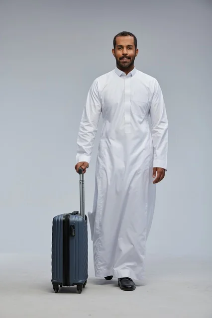 Saudi Man in White Thobe with Blue Suitcase