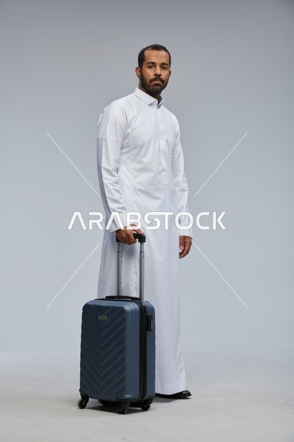 Saudi Man in White Thobe with Blue Suitcase