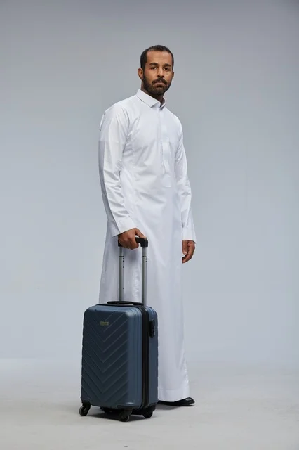 Saudi Man in White Thobe with Blue Suitcase