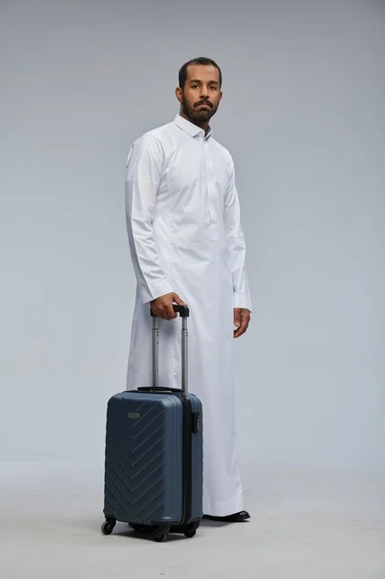 Saudi Man in White Thobe with Blue Suitcase