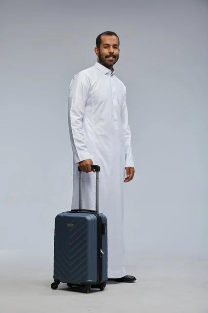 Saudi Man Traveler with Blue Suitcase in Studio