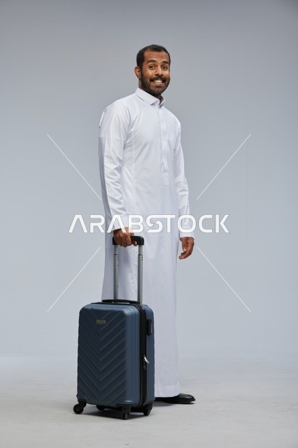 Saudi Man in White Thobe with Blue Suitcase