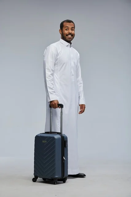 Saudi Man in White Thobe with Blue Suitcase