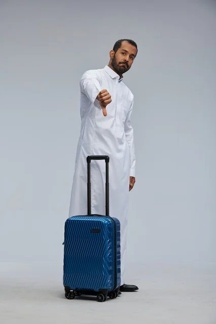 Saudi Man with Blue Suitcase Giving Thumbs Down