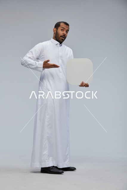 Saudi Man in Traditional Thobe Holding Blank White Board