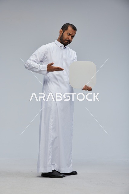 Saudi Man Holding Blank White Board in Traditional Thobe