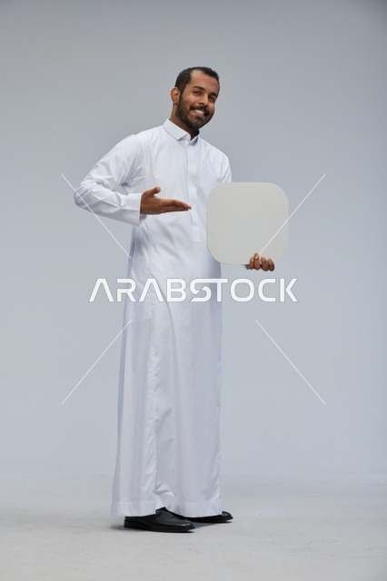 Saudi Man in Traditional Thobe Holding Blank White Board