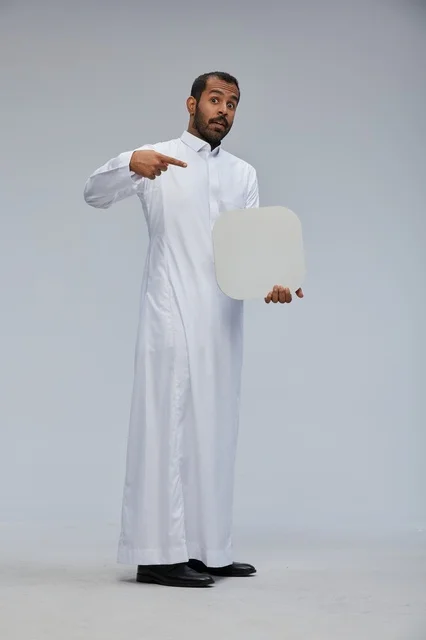 Saudi Man Pointing at Blank White Sign in Studio