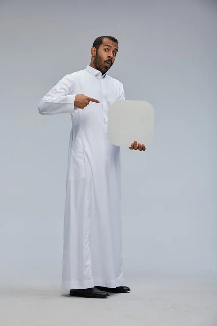Saudi Man Holding Blank Sign in Studio Setting