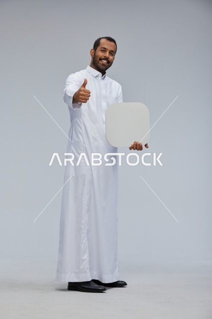 Saudi Man in Thobe Holding Blank Sign Board