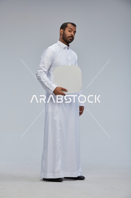 Saudi Man in Thobe Holding Blank Sign Studio