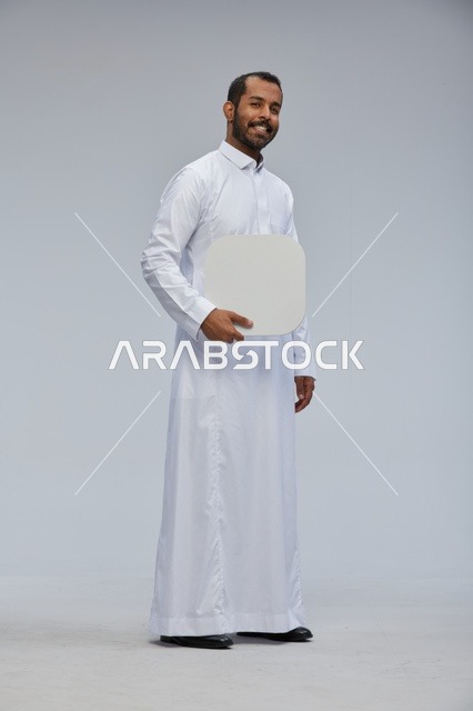 Saudi Man in Traditional Thobe Holding Blank Sign Board