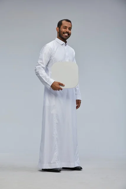 Saudi Man in Thobe Holding Blank Board in Studio