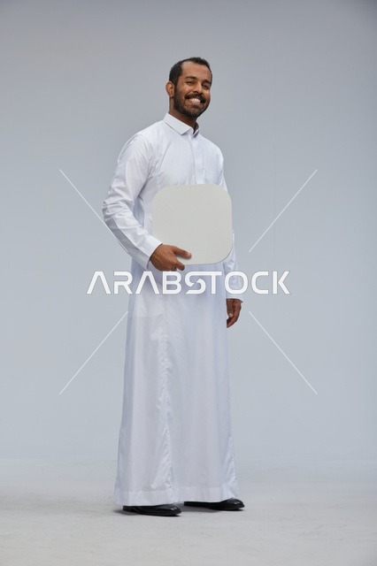 Saudi Man in White Thobe Holding Blank White Board