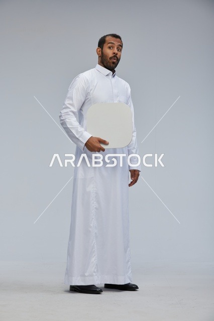 Saudi Man Holding Blank White Board with Surprised Face