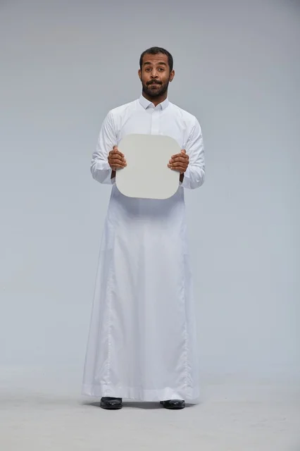 Saudi Man in Thobe Holding Blank White Board