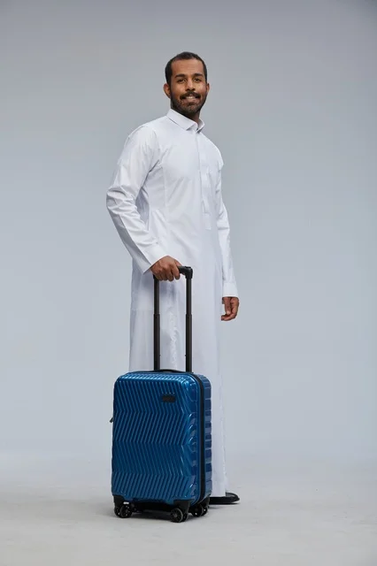 Saudi Traveler in White Thobe Holding Blue Suitcase