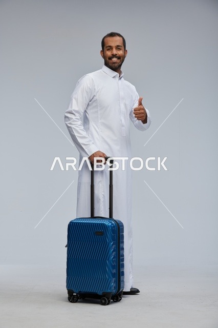 Saudi Man in White Thobe with Blue Suitcase