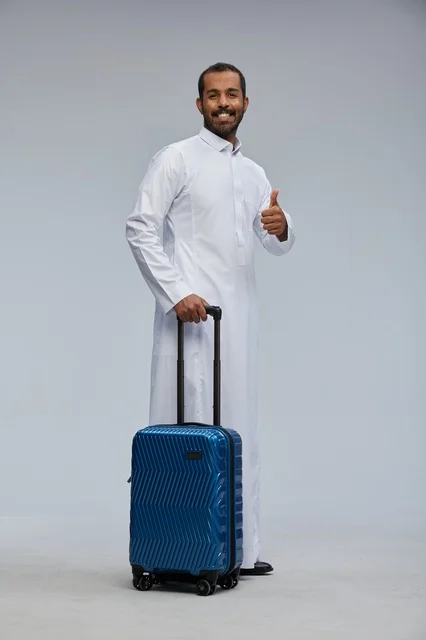 Saudi Man in White Thobe with Blue Suitcase