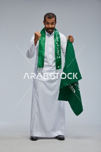 Saudi Man Holding National Flag Celebrating Success