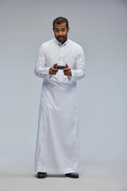 Saudi Man in Traditional Thobe Gaming in Studio