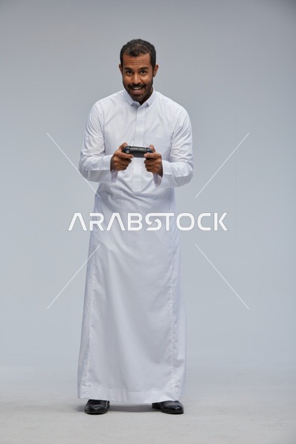Saudi Man Playing Video Games in Traditional Thobe