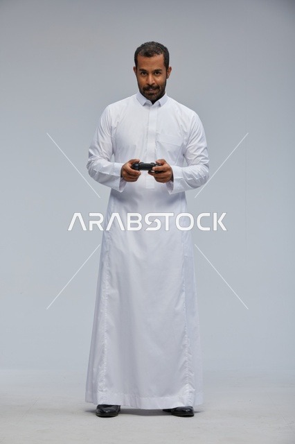 Saudi Man in Traditional Thob Holding Game Controller