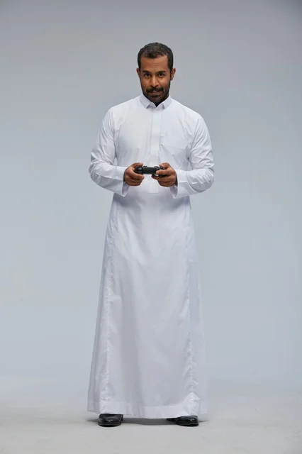 Saudi Man in Traditional Thob Holding Game Controller