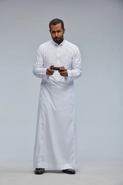 Saudi Man with Game Controller on Grey Background