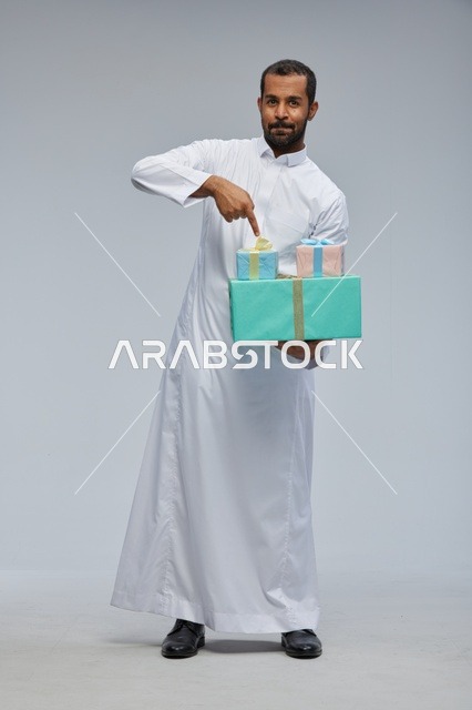 Saudi Man in Traditional Thobe Holding Gift Boxes