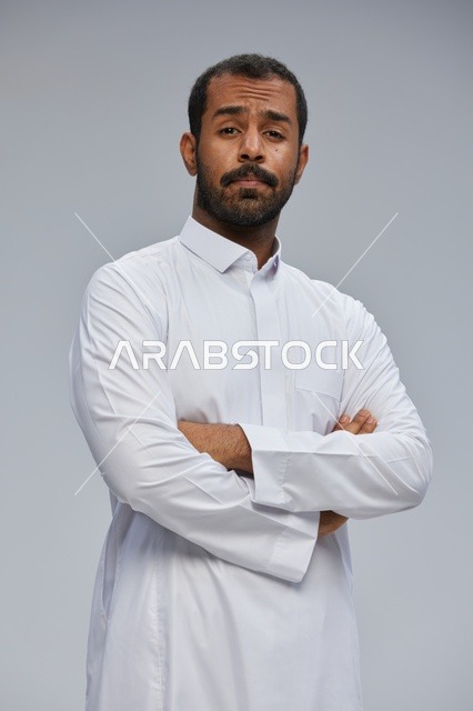 Saudi Man in White Thobe with Crossed Arms