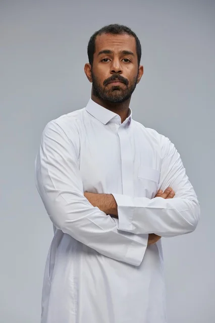Saudi Man Wearing White Thobe with Crossed Arms Studio
