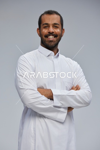 Saudi Man in White Thobe with Crossed Arms