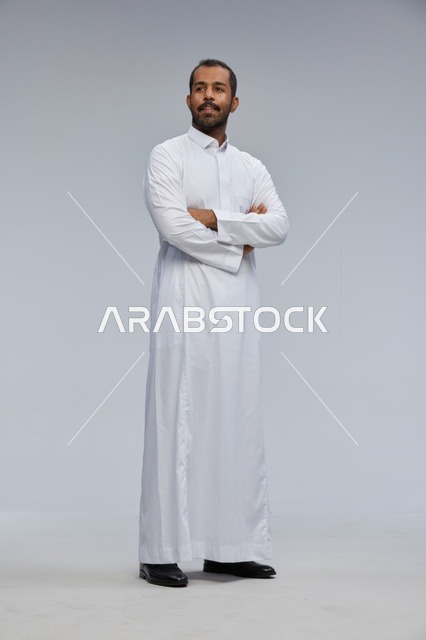Saudi Man in White Thobe with Arms Crossed in Studio