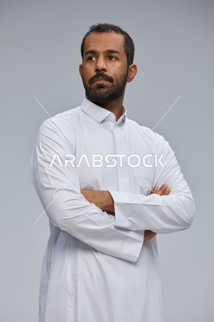 Saudi Man in White Thobe with Crossed Arms Portrait