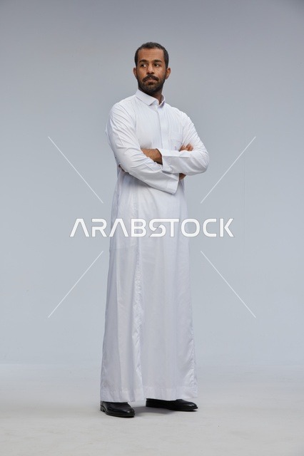 Saudi Man in White Thobe with Crossed Arms